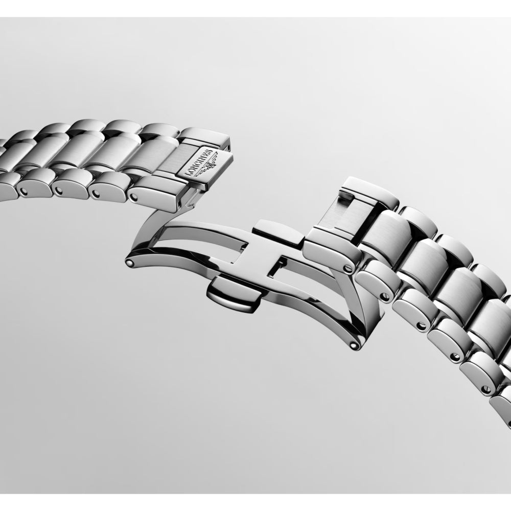 Longines stainless steel automatic watch with a mother of pearl diamond index dial on a white background