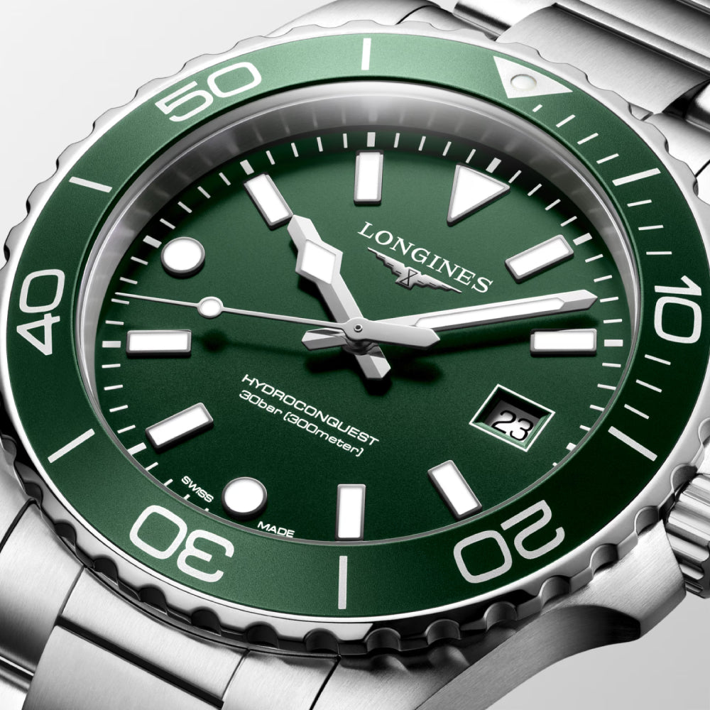 Green and silver Longines watch with detailed design
