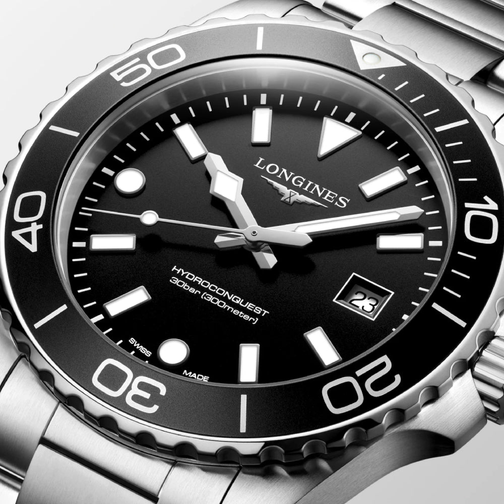Longines watch with black dial and silver case on a white background