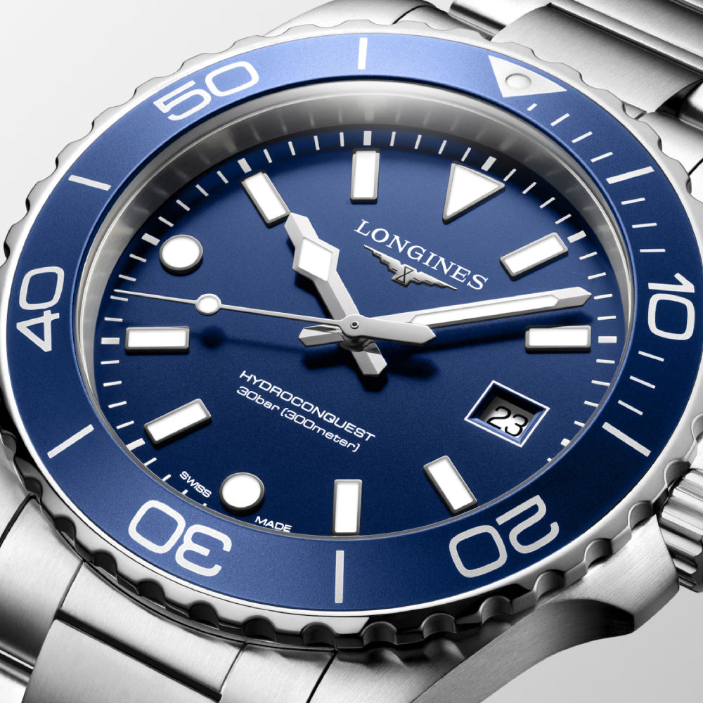 Longines watch with blue dial and silver case on a white background