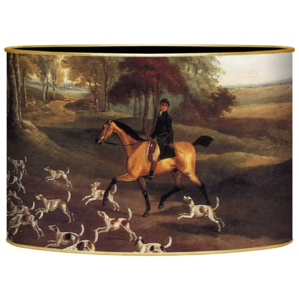A cylindrical desk organizer featuring a classic oil painting print of a horse rider on a tan horse hunting dogs in a forested landscape, framed by a thin gold border.