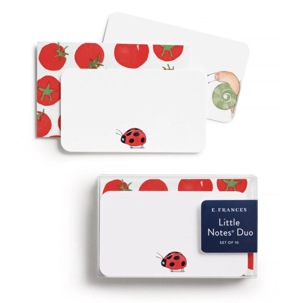 Note pads with tomato and ladybug design on a white background.