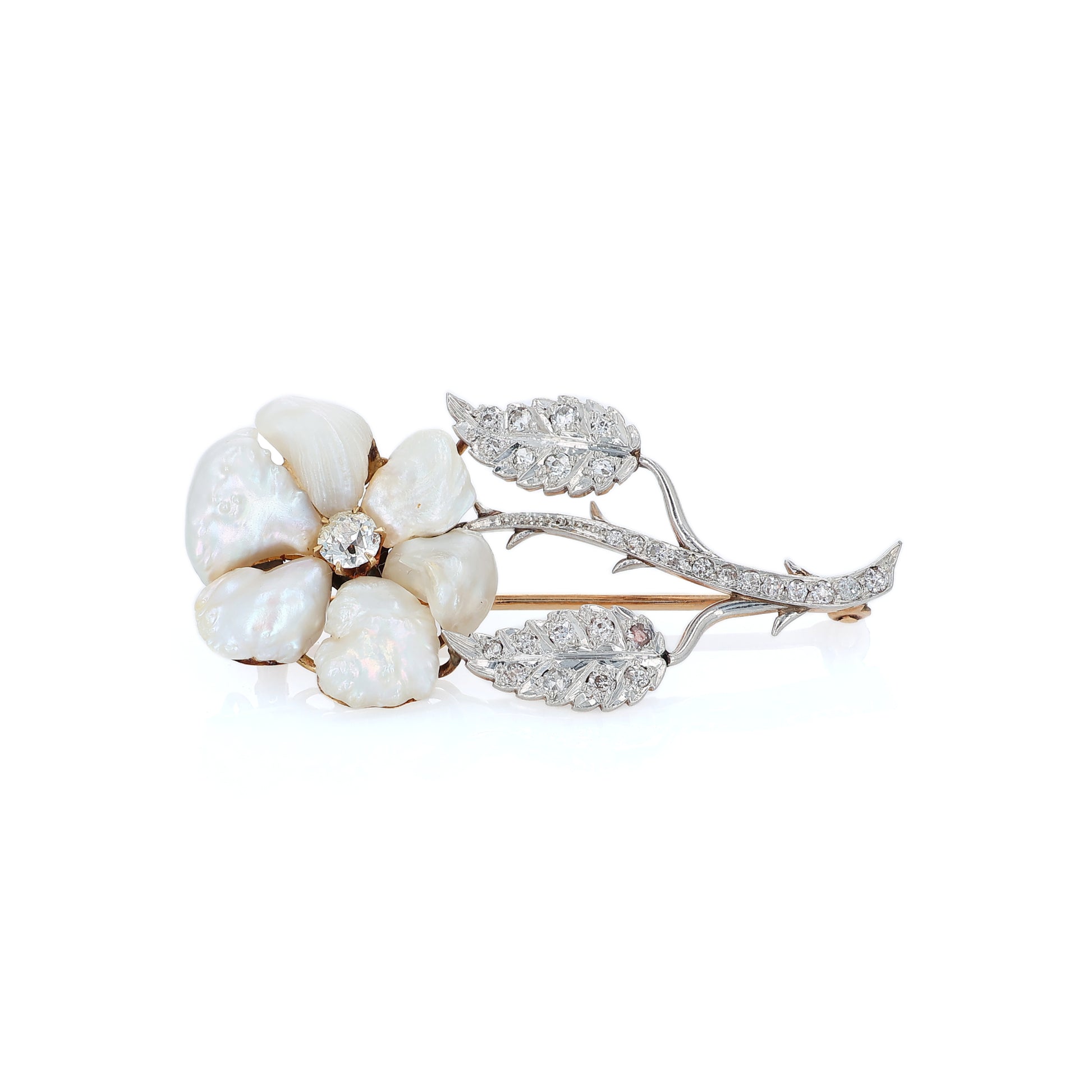 Platinum and yellow gold flower design pin with pearl petals and diamond accents on a white background