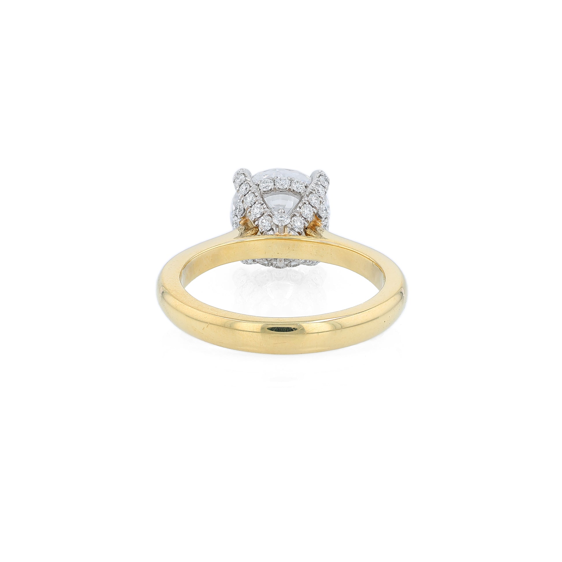 Yellow gold and platinum diamond engagement ring with diamond accents and a round cubic zirconia center on a white background