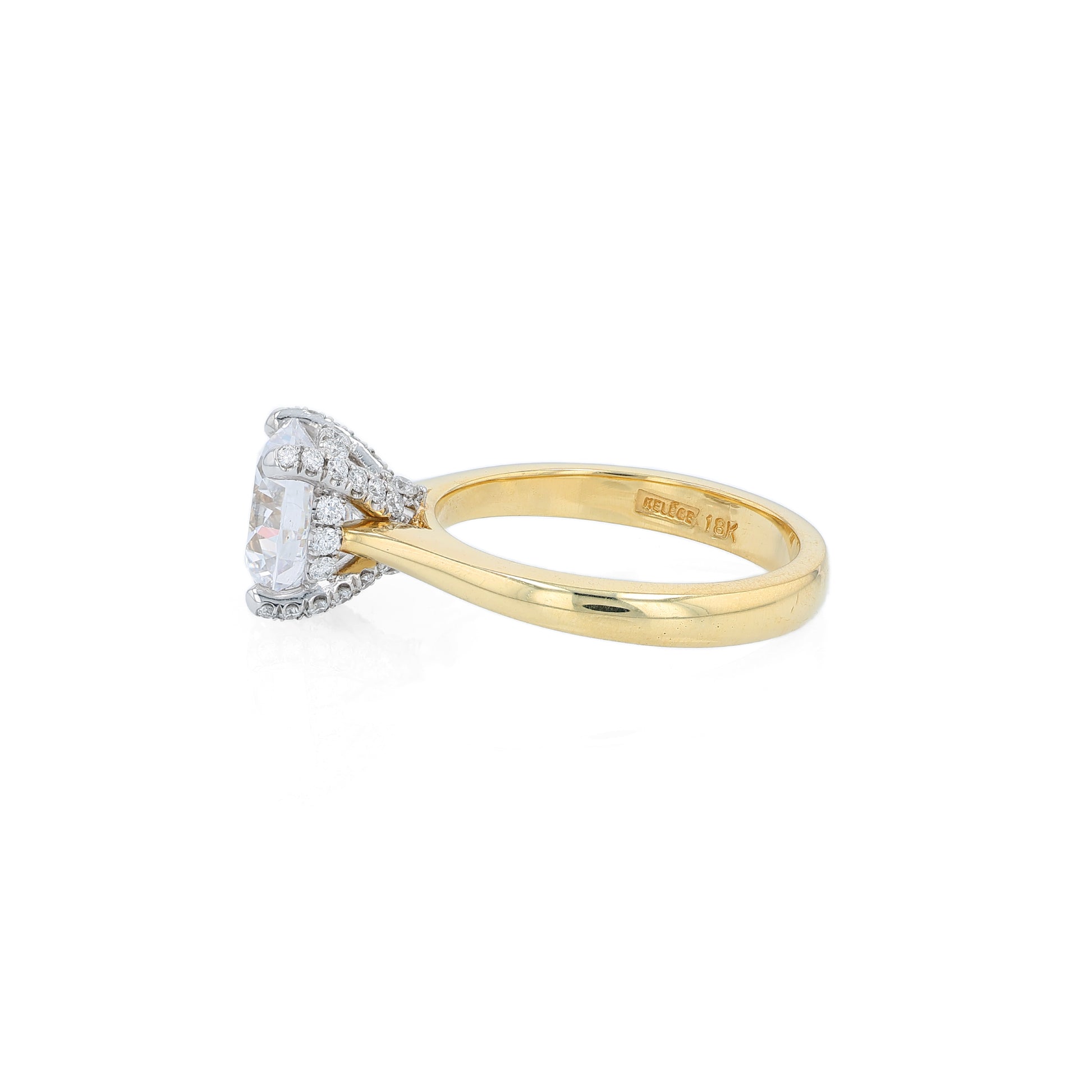 Yellow gold and platinum diamond engagement ring with diamond accents and a round cubic zirconia center on a white background
