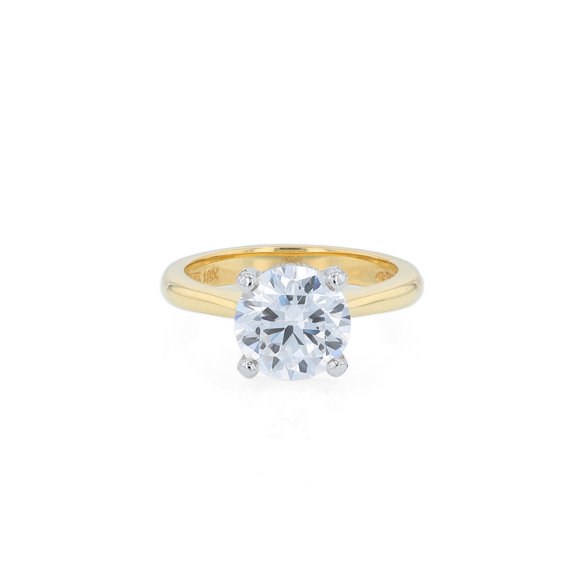 Yellow gold and platinum diamond engagement ring with diamond accents and a round cubic zirconia center on a white background