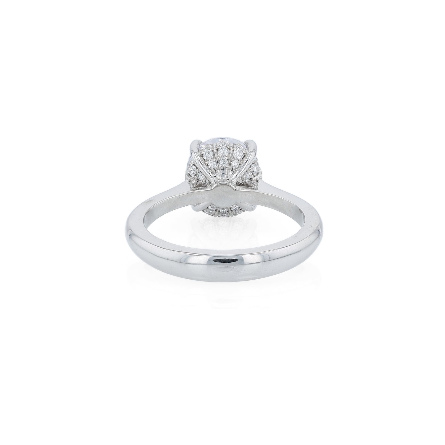 Platinum diamond engagement ring with diamond accents under the head and a round cubic zirconia center on a white background