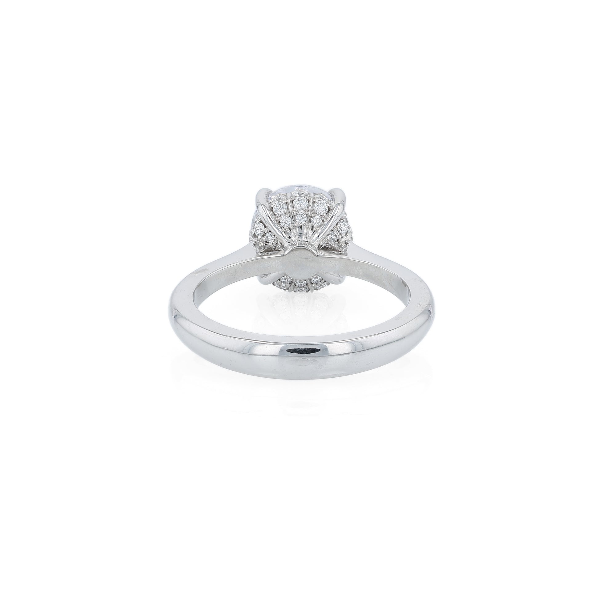 Platinum diamond engagement ring with diamond accents under the head and a round cubic zirconia center on a white background