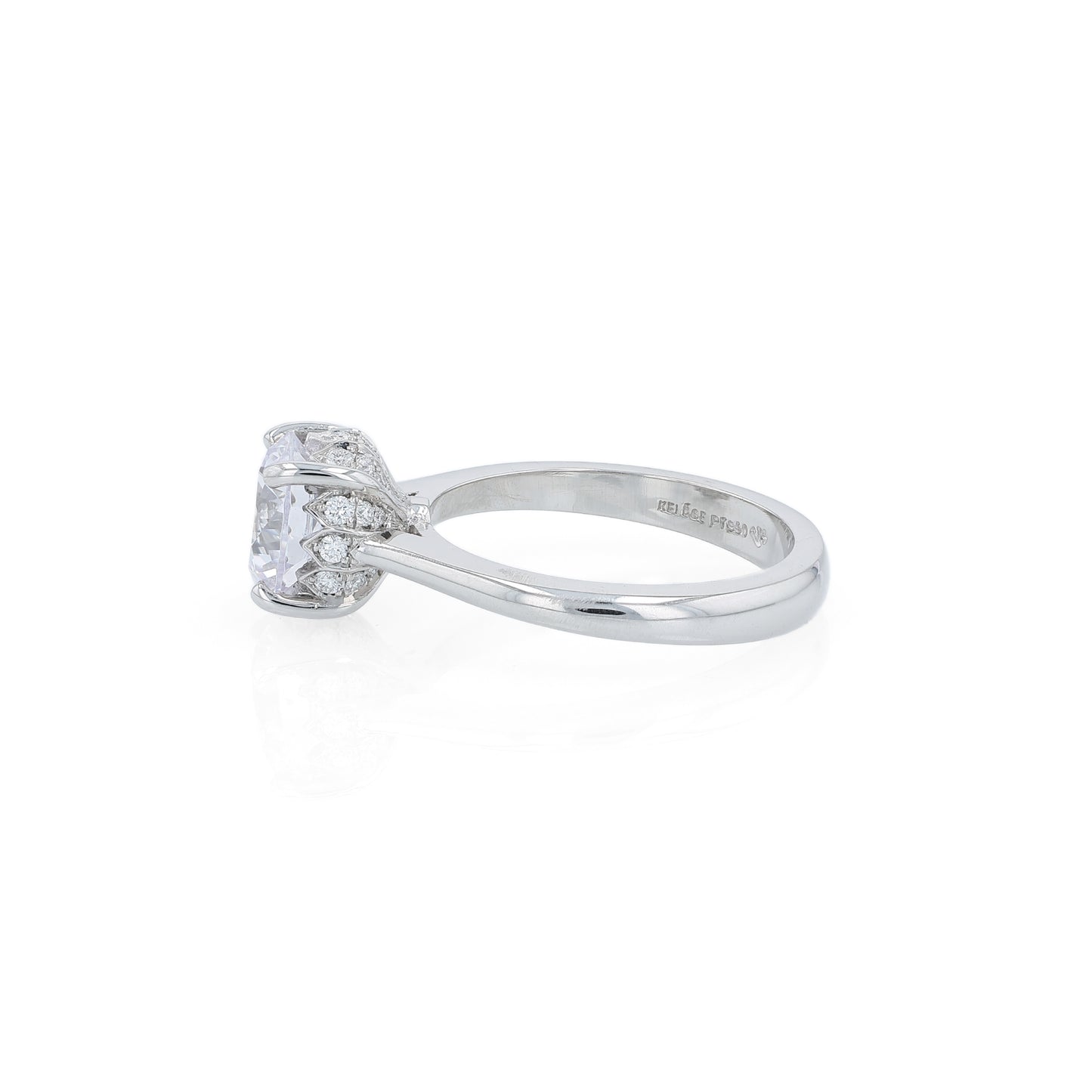 Platinum diamond engagement ring with diamond accents under the head and a round cubic zirconia center on a white background