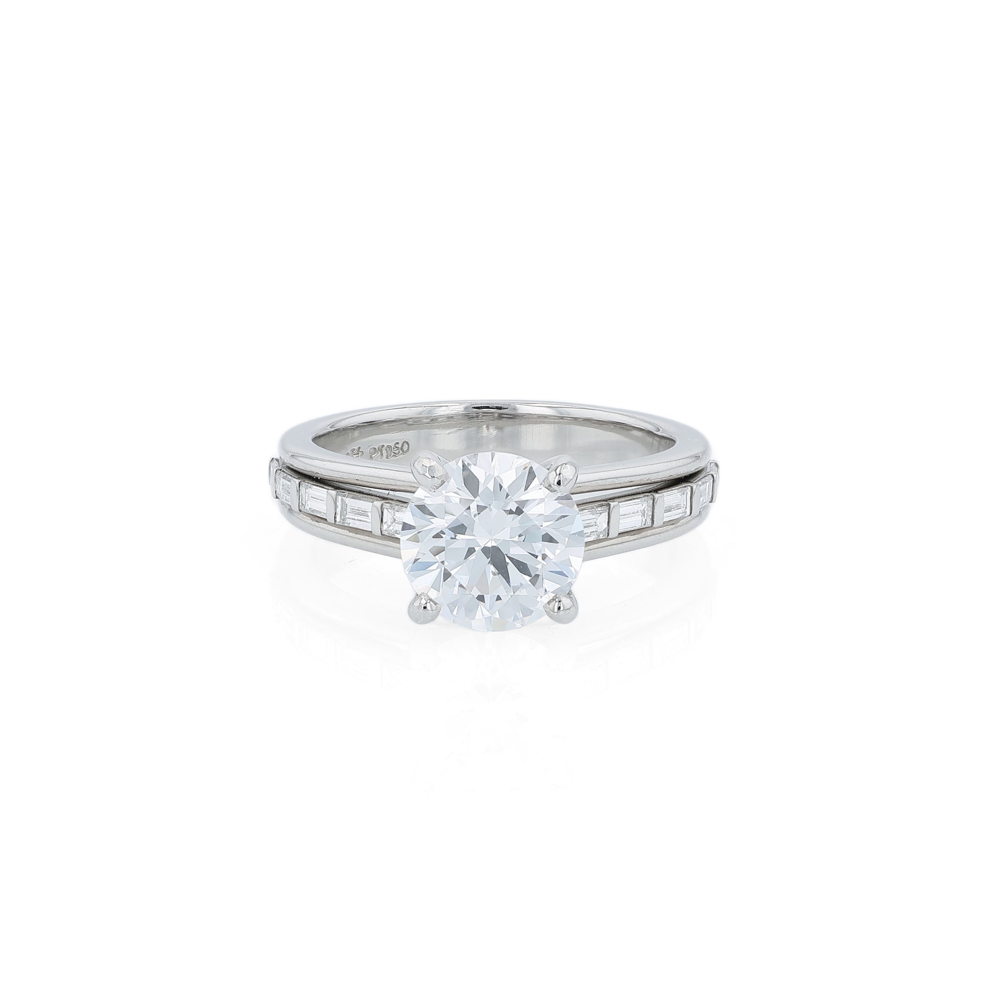 Platinum diamond engagement ring with baguette diamond accents a round cubic zirconia center on a white background