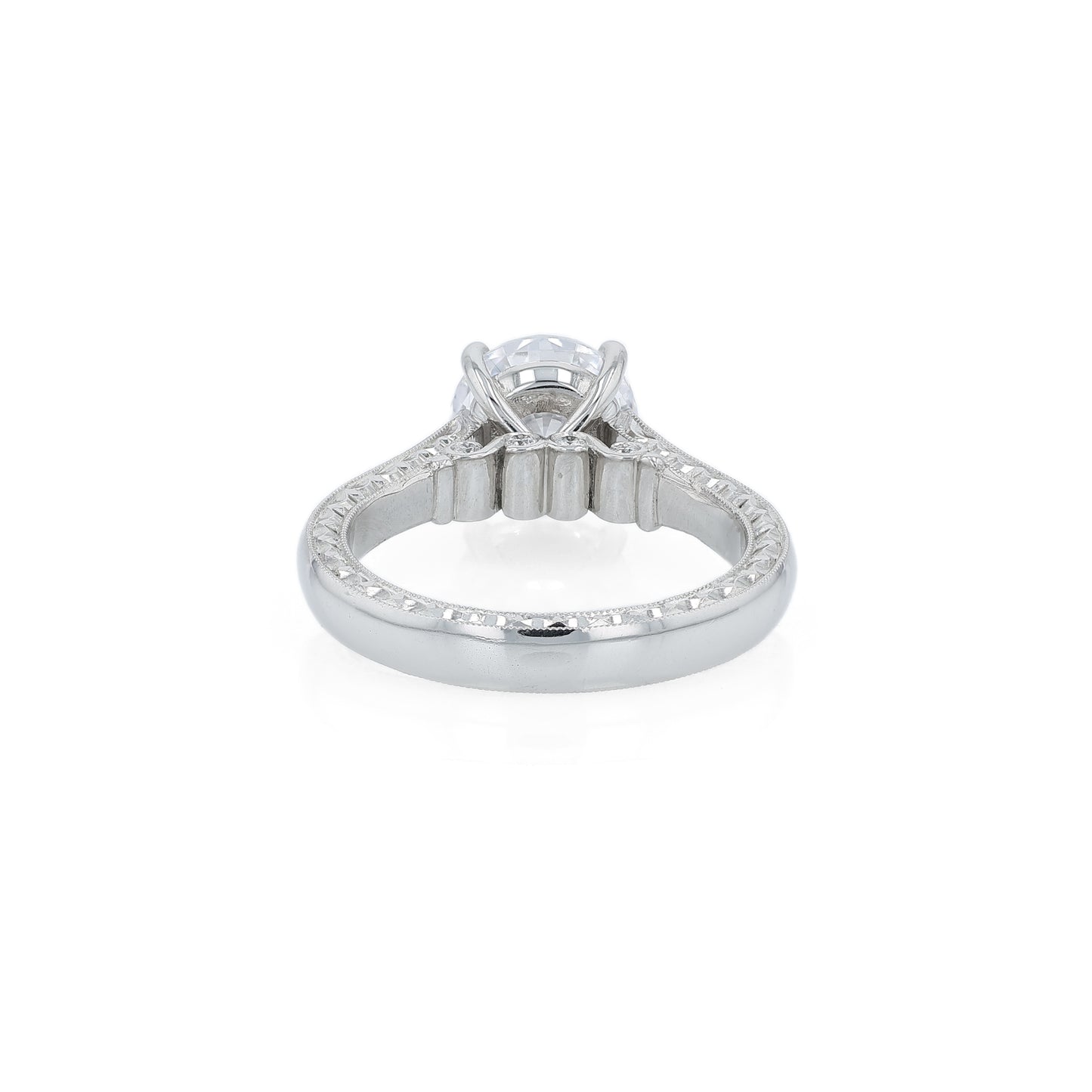 Platinum diamond solitaire engagement ring with diamond accents and a round cubic zirconia center on a white background
