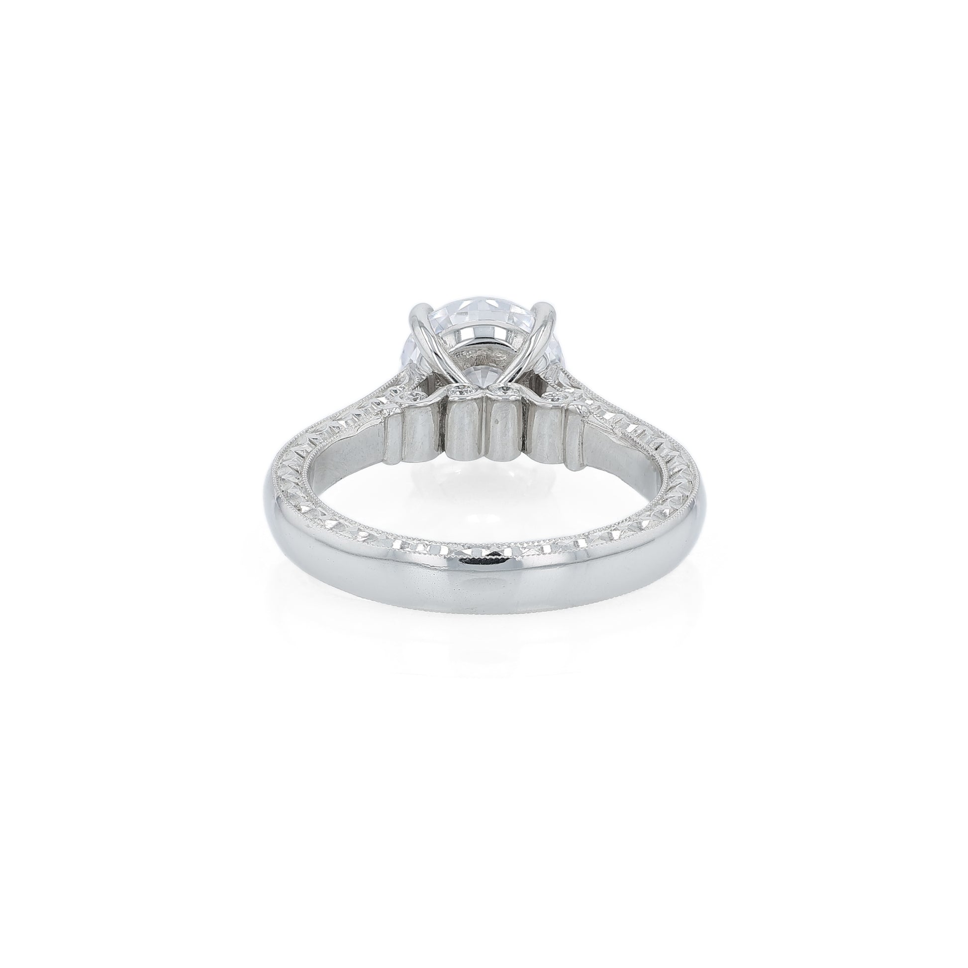 Platinum diamond solitaire engagement ring with diamond accents and a round cubic zirconia center on a white background