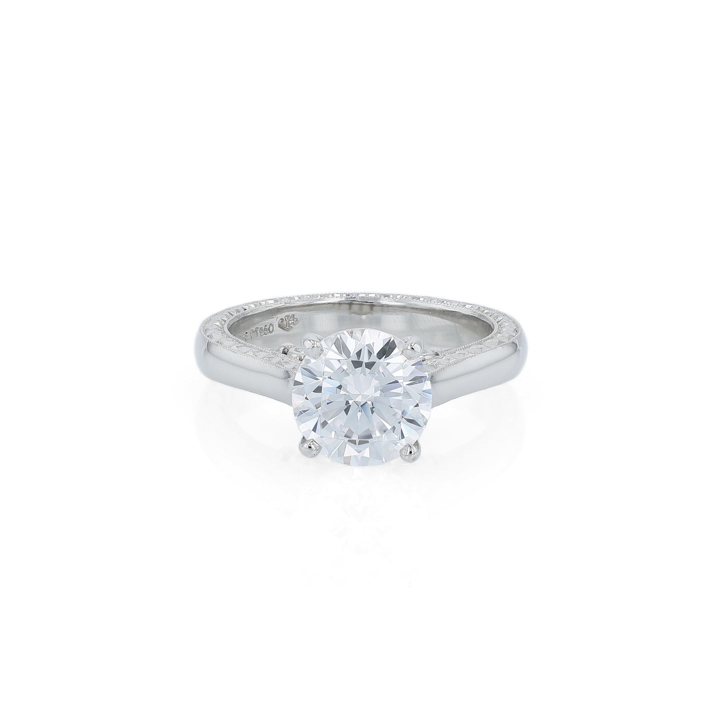 Platinum diamond solitaire engagement ring with a round cubic zirconia center on a white background