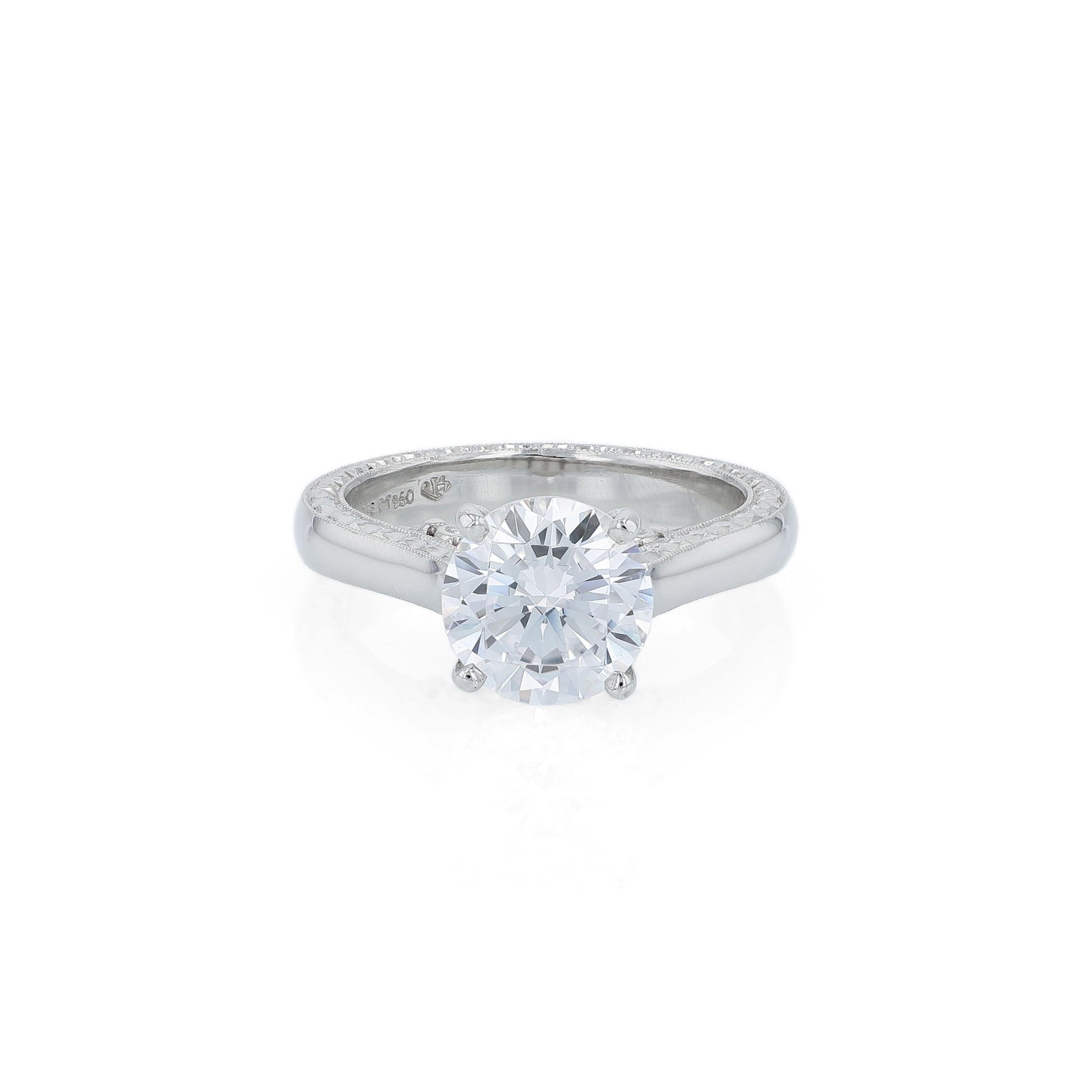 Platinum diamond solitaire engagement ring with a round cubic zirconia center on a white background