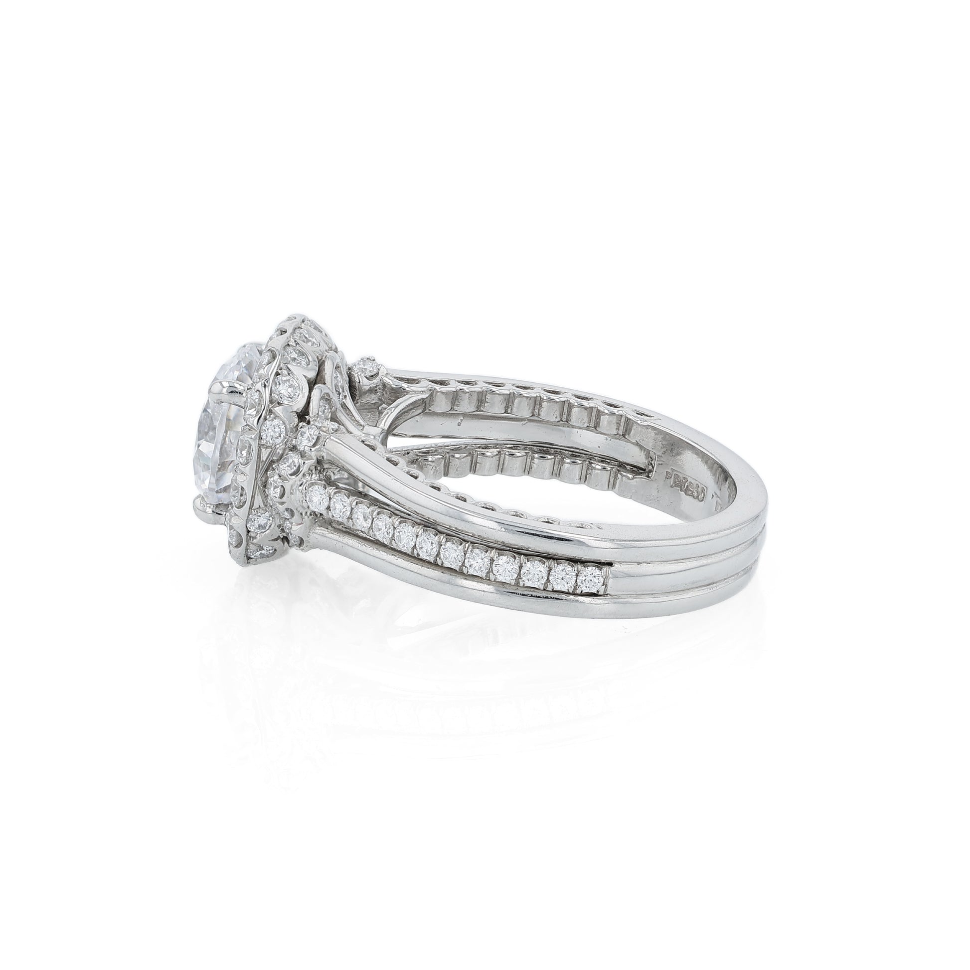 Platinum diamond halo engagement ring with diamond accents and a round cubic zirconia center on a white background