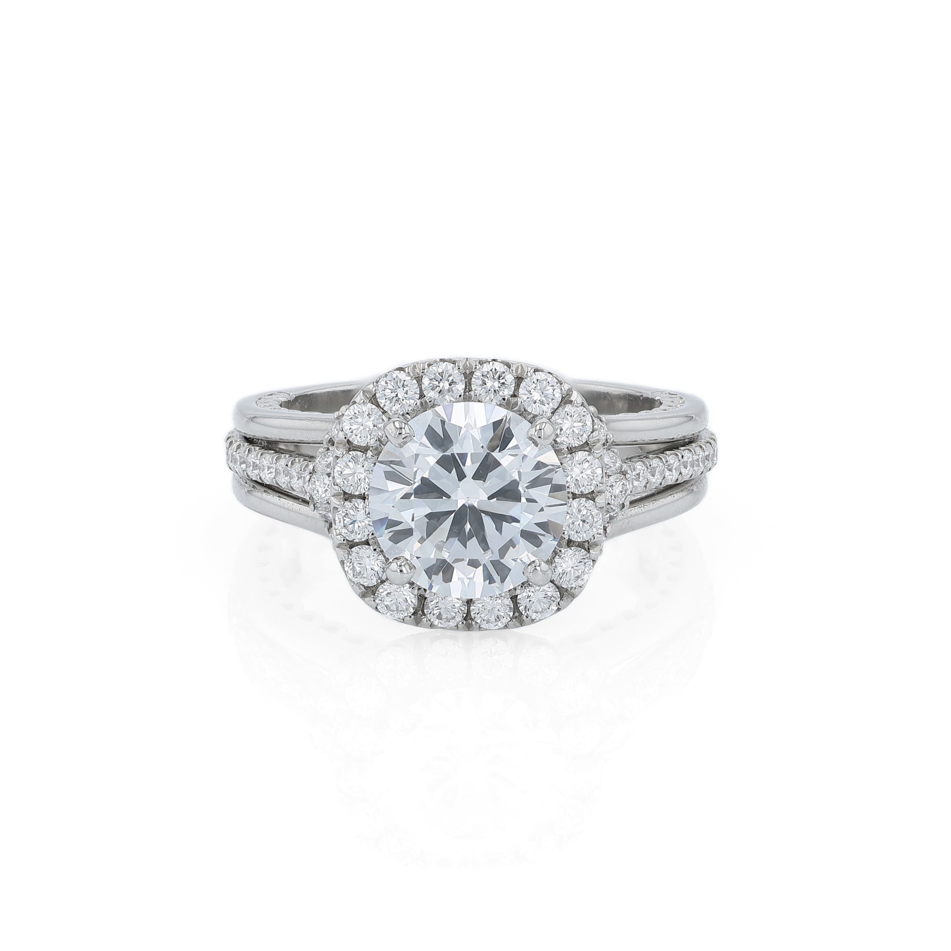 Platinum diamond halo engagement ring with diamond accents and a round cubic zirconia center on a white background