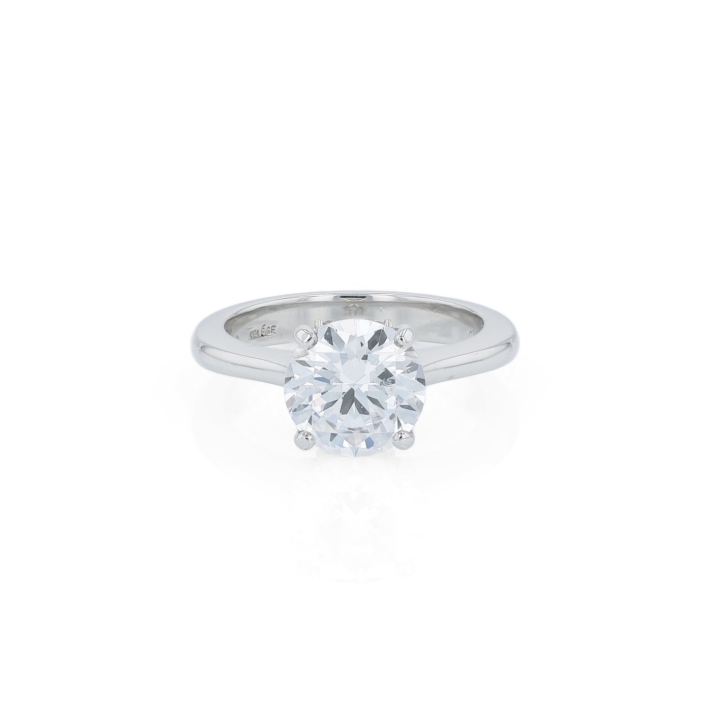 Platinum diamond solitaire engagement ring with a round cubic zirconia center on a white background
