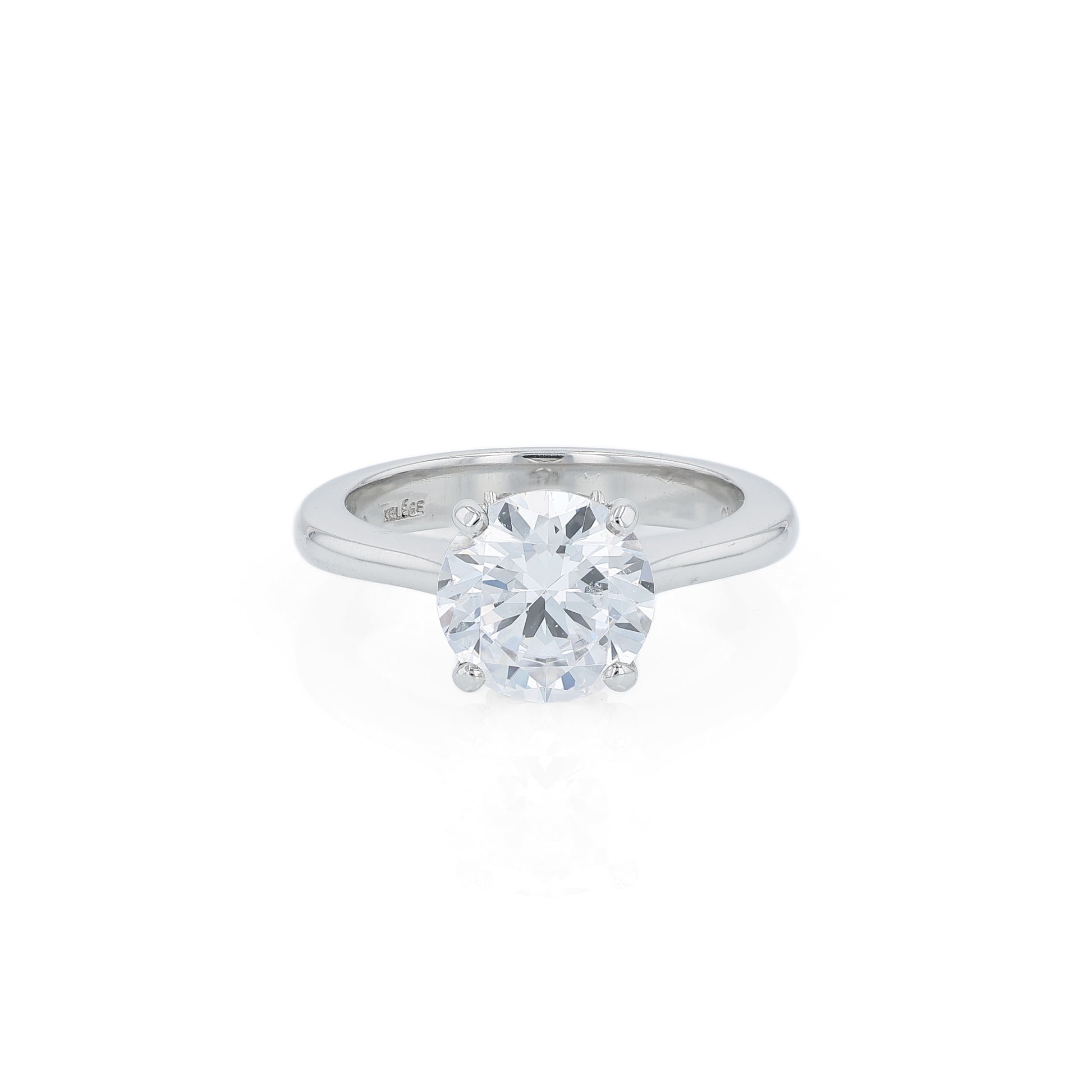 Platinum diamond solitaire engagement ring with a round cubic zirconia center on a white background