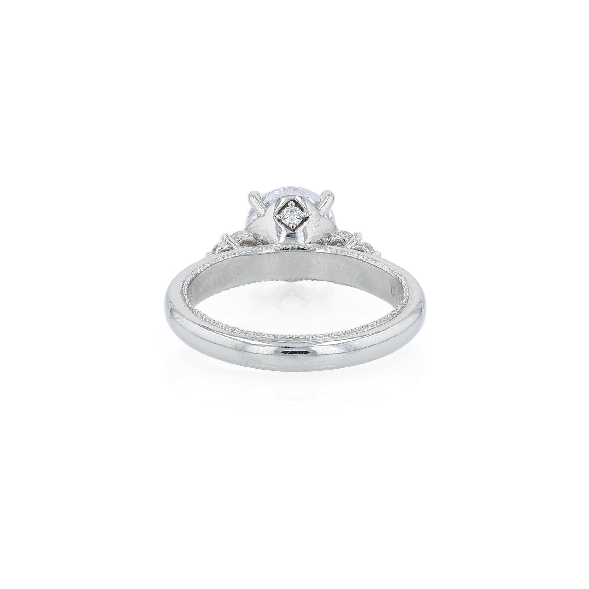 Platinum diamond engagement ring with diamond accents and a round cubic zirconia center on a white background