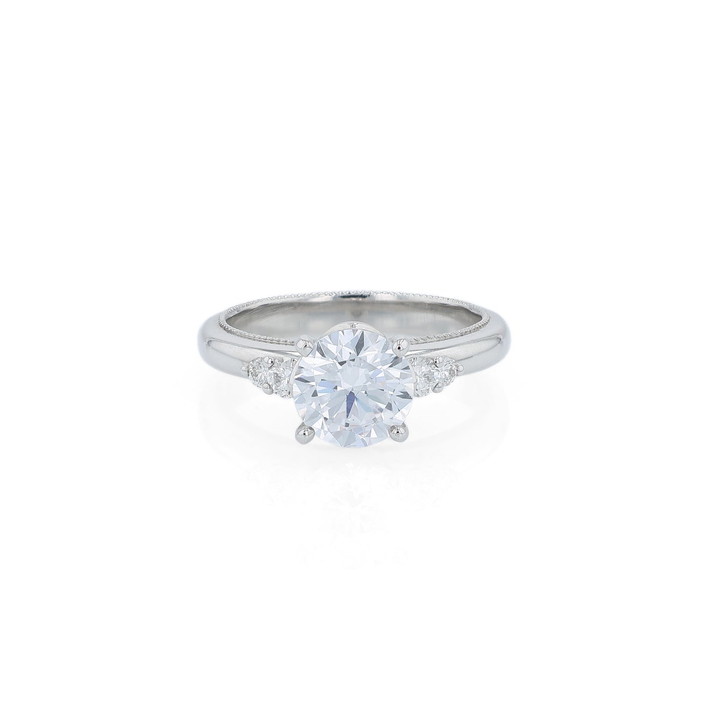 Platinum diamond engagement ring with diamond accents and a round cubic zirconia center on a white background