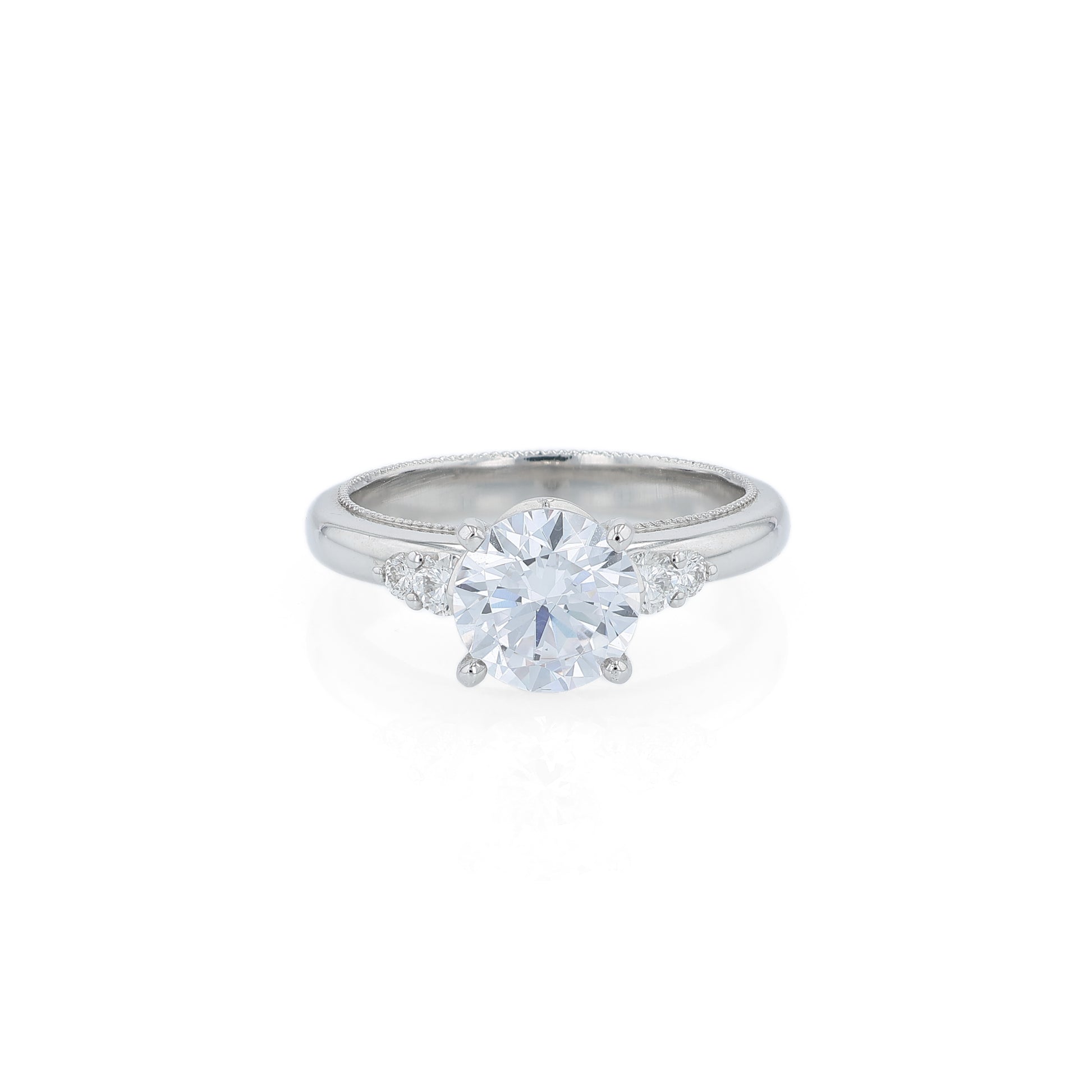 Platinum diamond engagement ring with diamond accents and a round cubic zirconia center on a white background