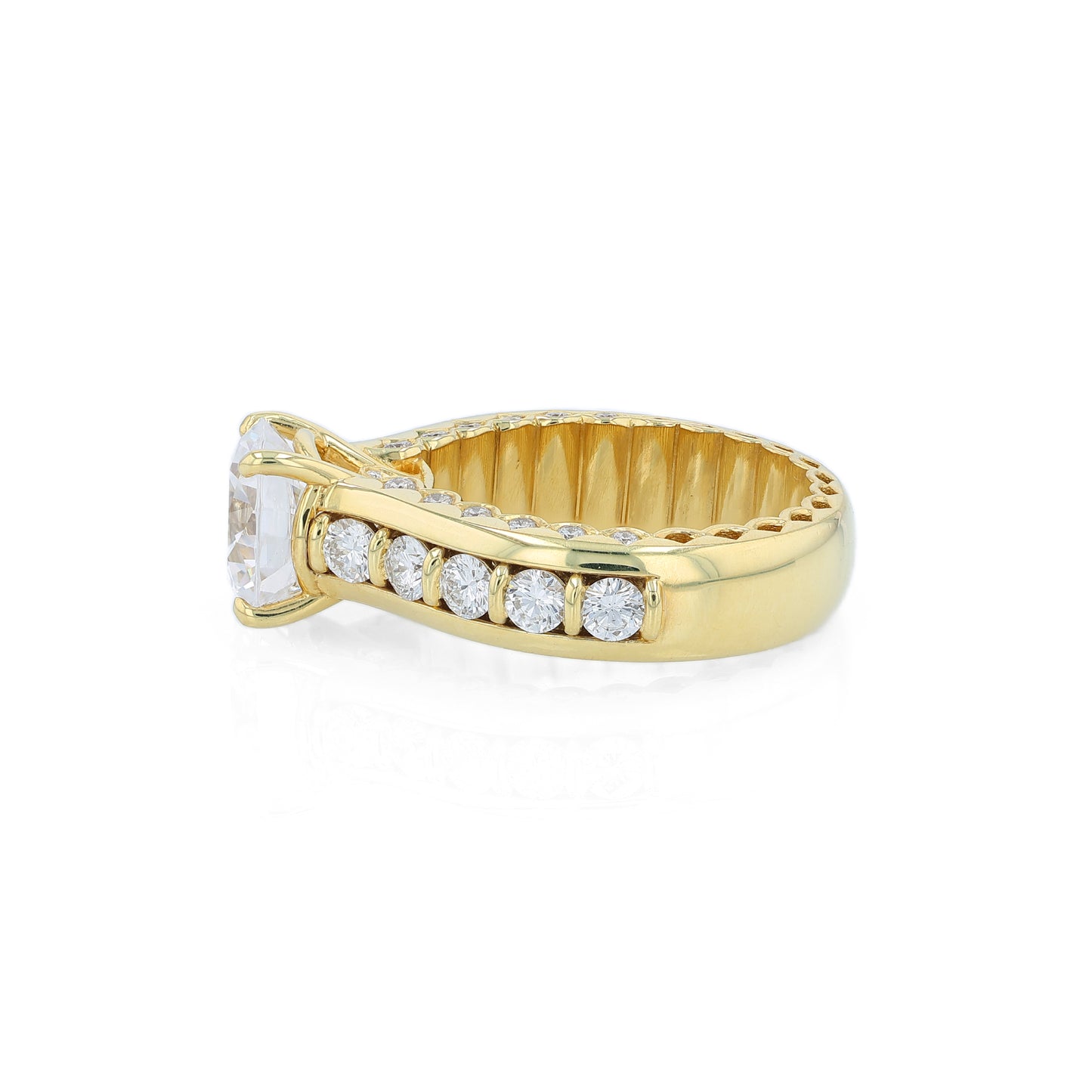 Yellow gold diamond engagement ring with diamond accents and a round cubic zirconia center on a white background