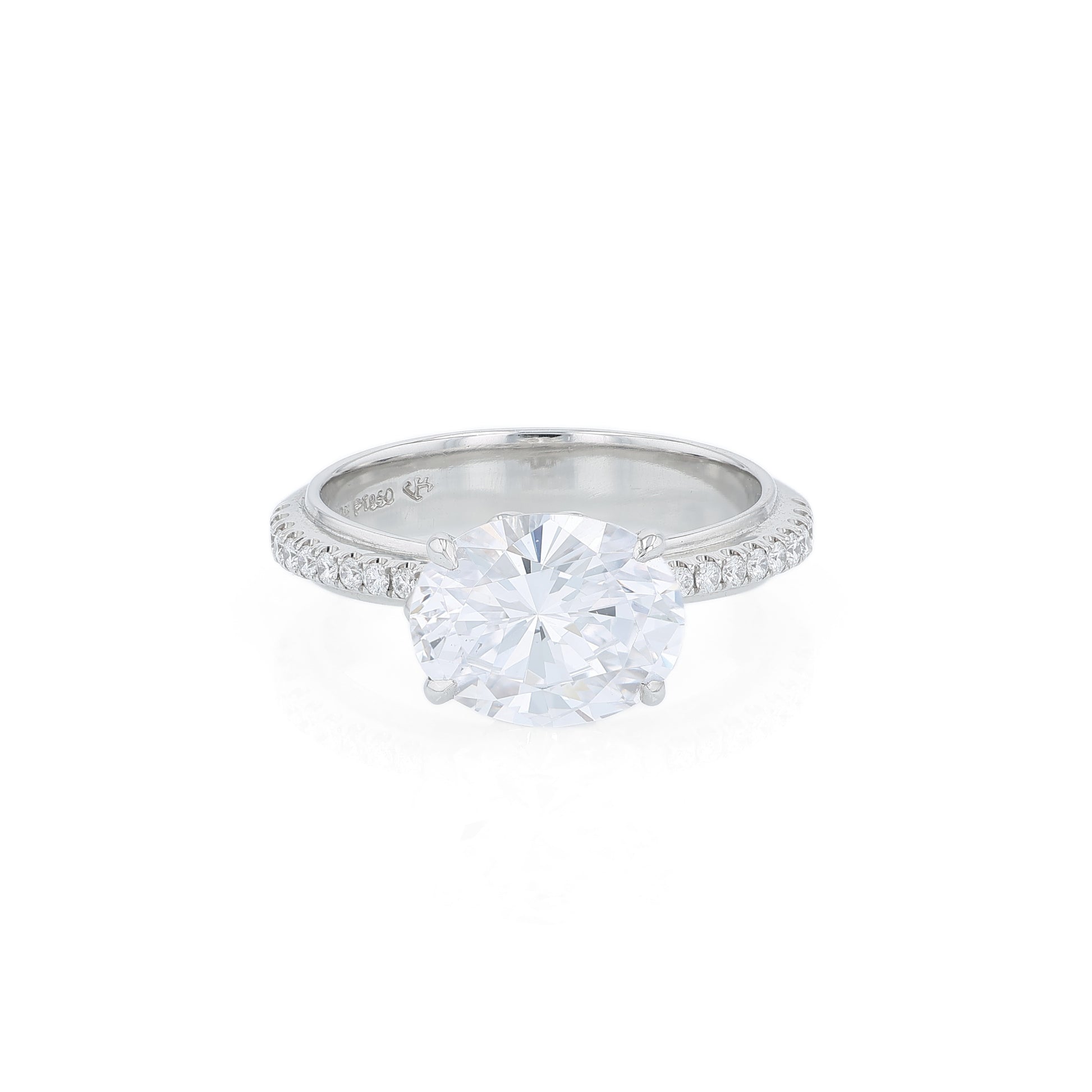 Platinum diamond engagement ring with diamond accents and an oval cubic zirconia center on a white background