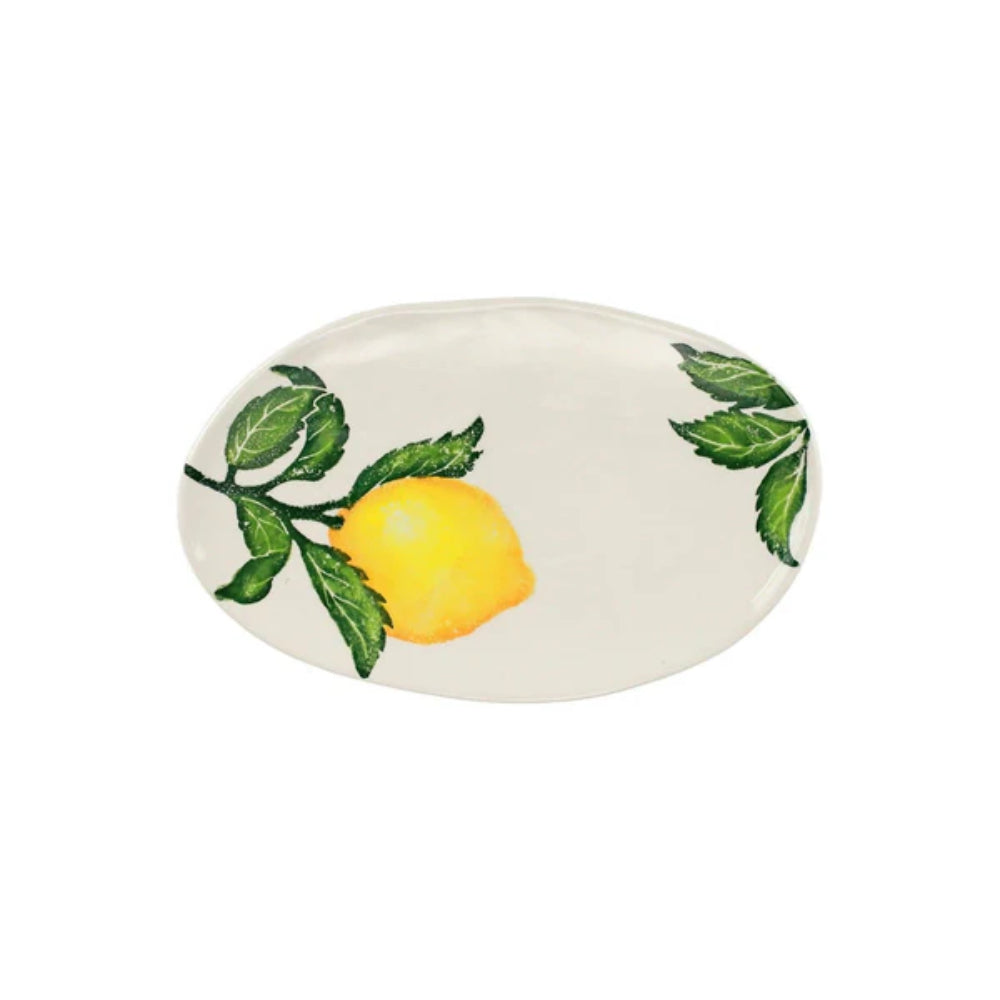 A small oval platter with a white background featuring a handpainted lemon and green leaves design.