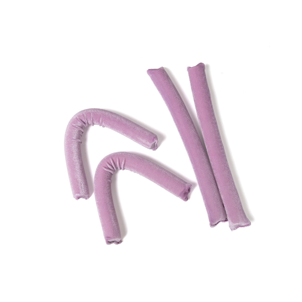 Set of pink foam rollers on a white background