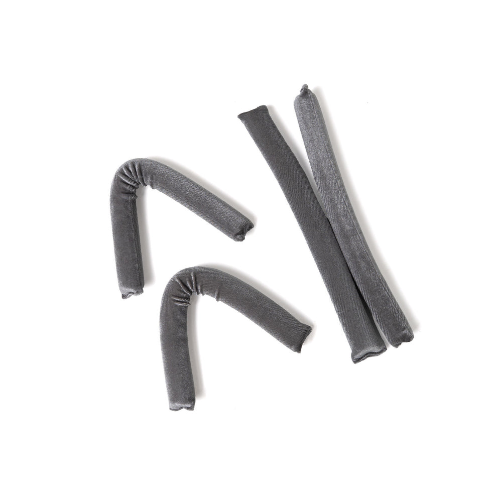 Four gray hair rollers on a white background