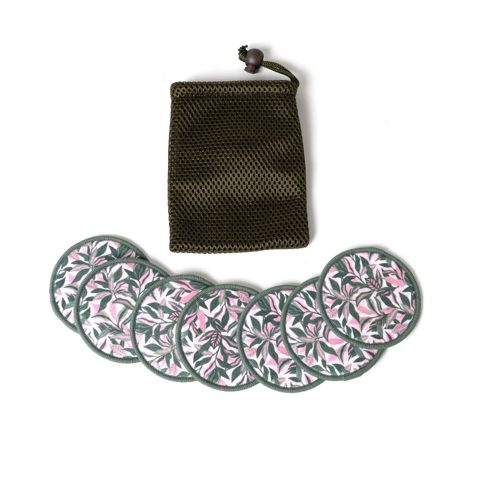 Set of six round face pads with floral pattern and a black mesh pouch on a white background