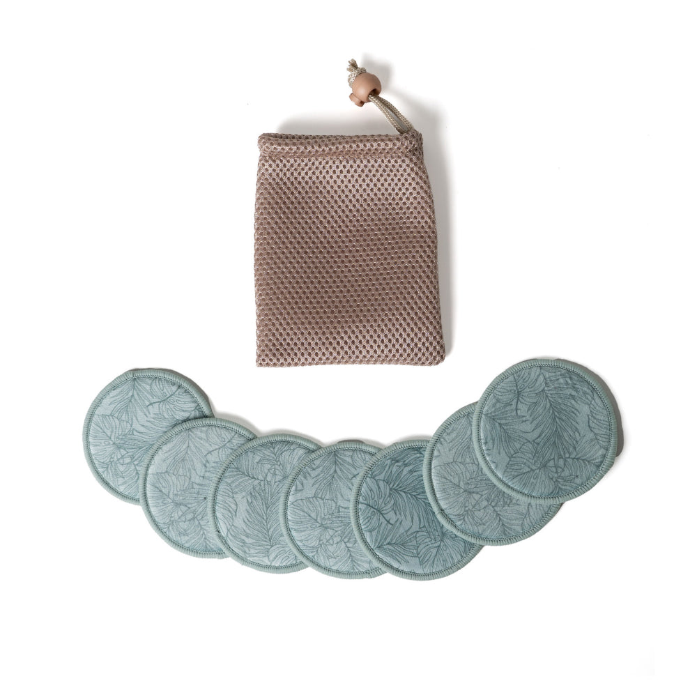 Set of six green leaf-patterned face pads with a woven pouch on a white background