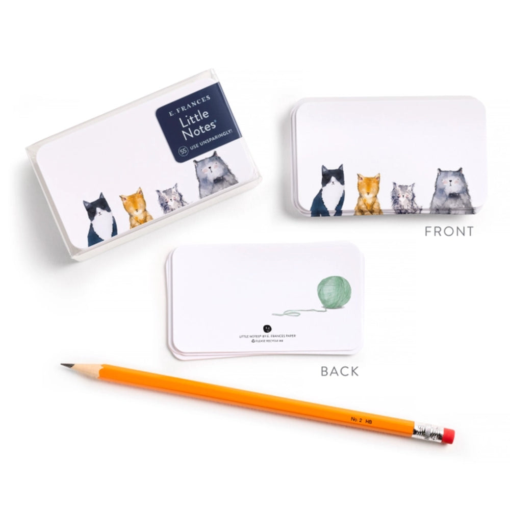 Notebook with cat illustrations, pencil, and box on a white background.