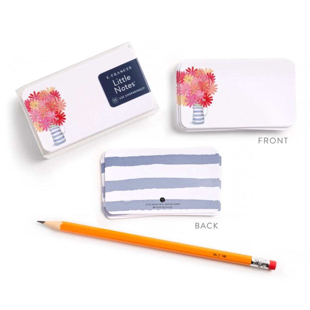 Two small notecards with floral and striped designs, accompanied by a pencil on a white background.