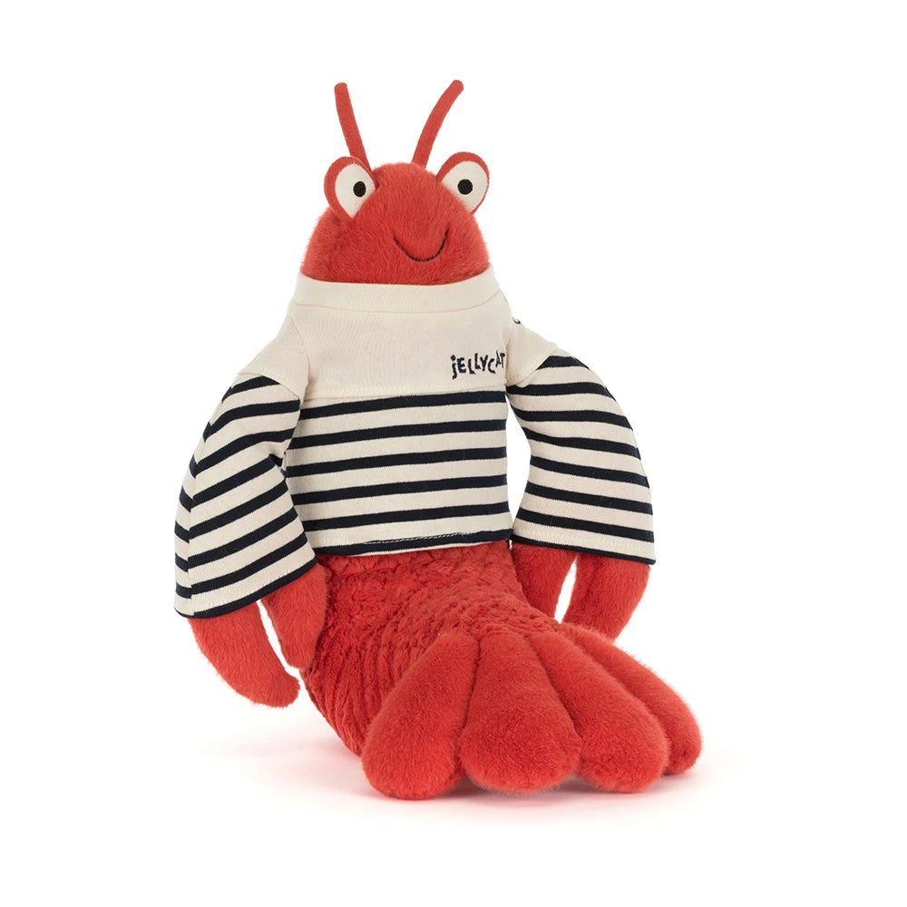 A angled photo of stuffed animal red lobster in a sailor outfit with a white & blue striped shirt that says "Jellycat" in the upper left hand corner in blue on a white backround 