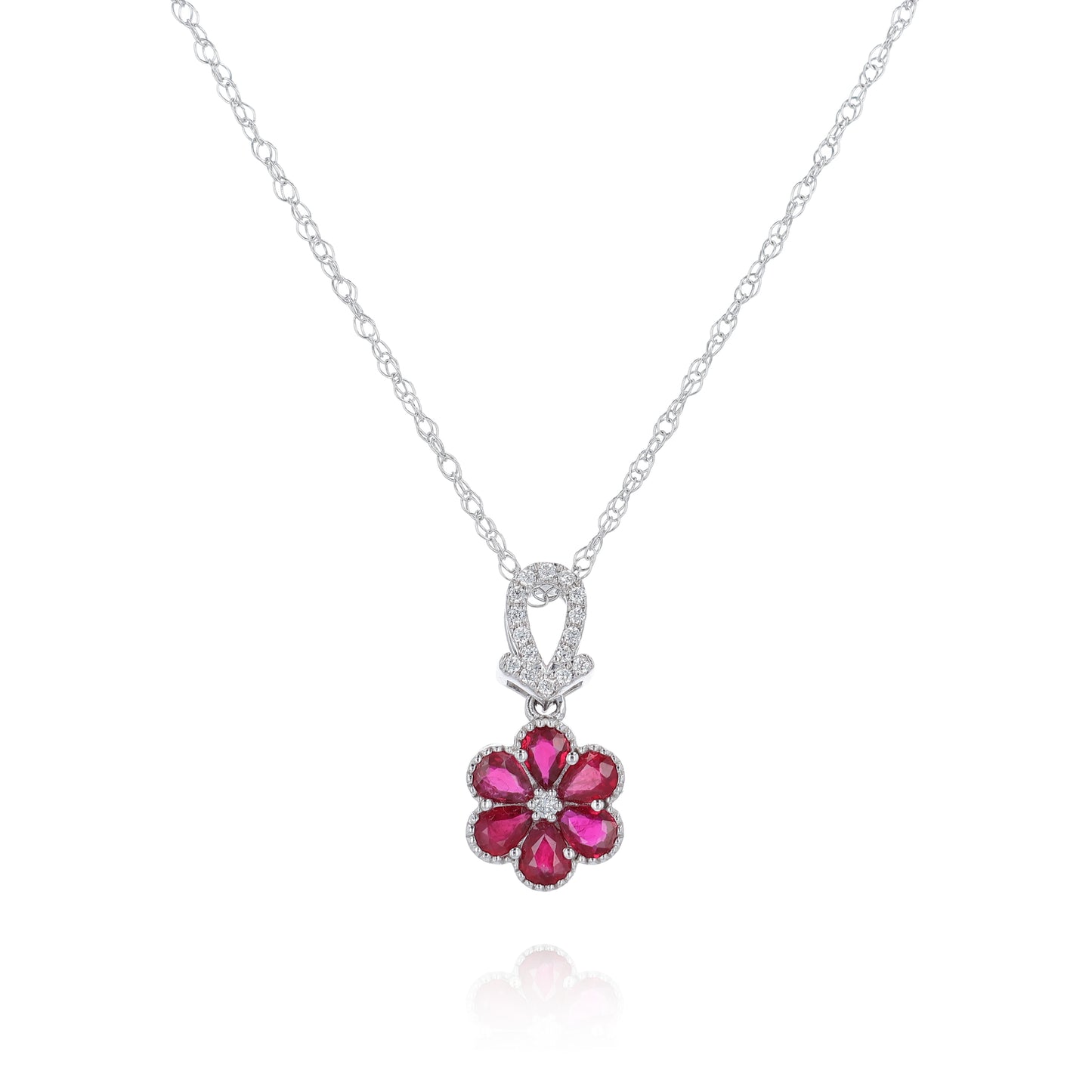 White gold flower design ruby and diamond pendant necklace on a white background