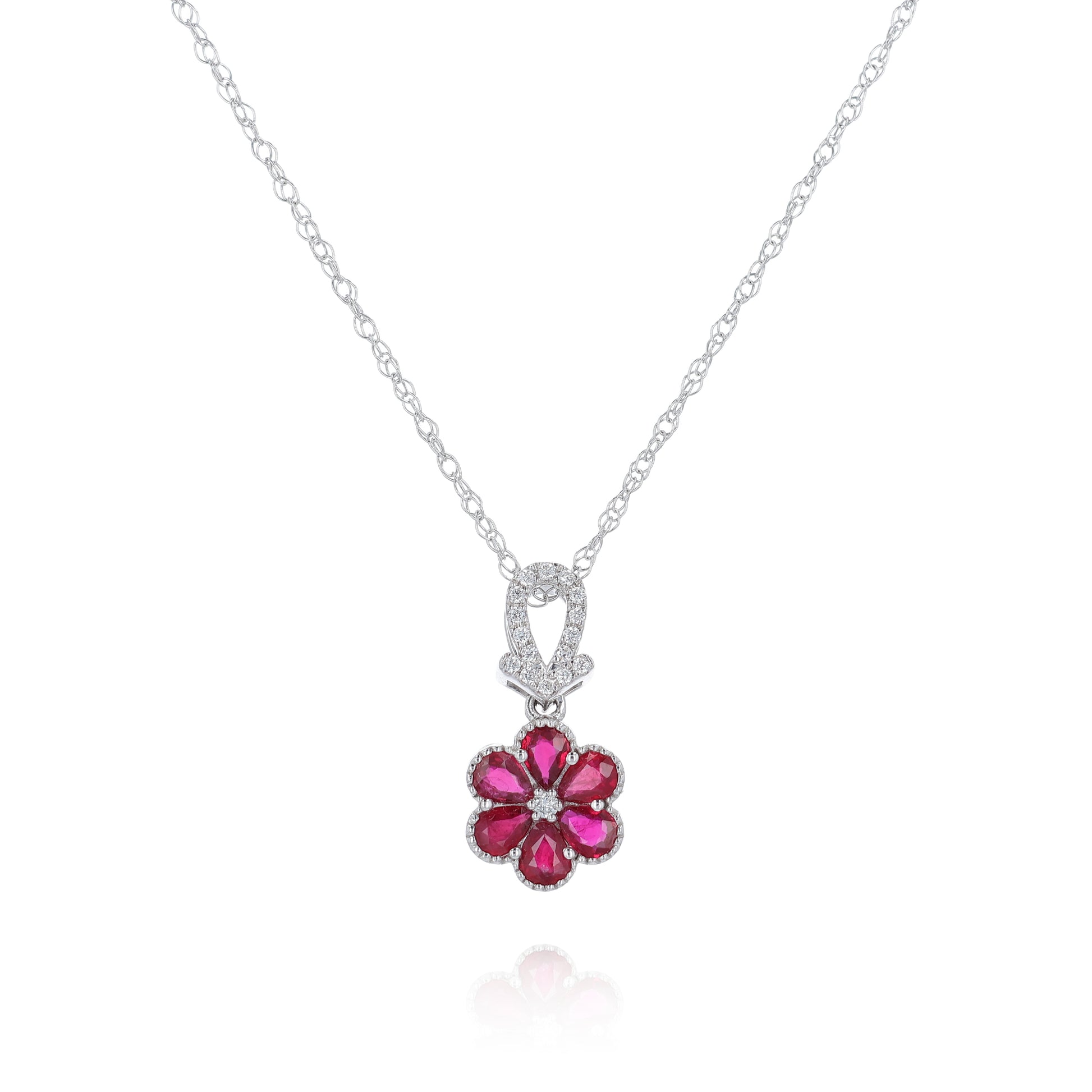 White gold flower design ruby and diamond pendant necklace on a white background