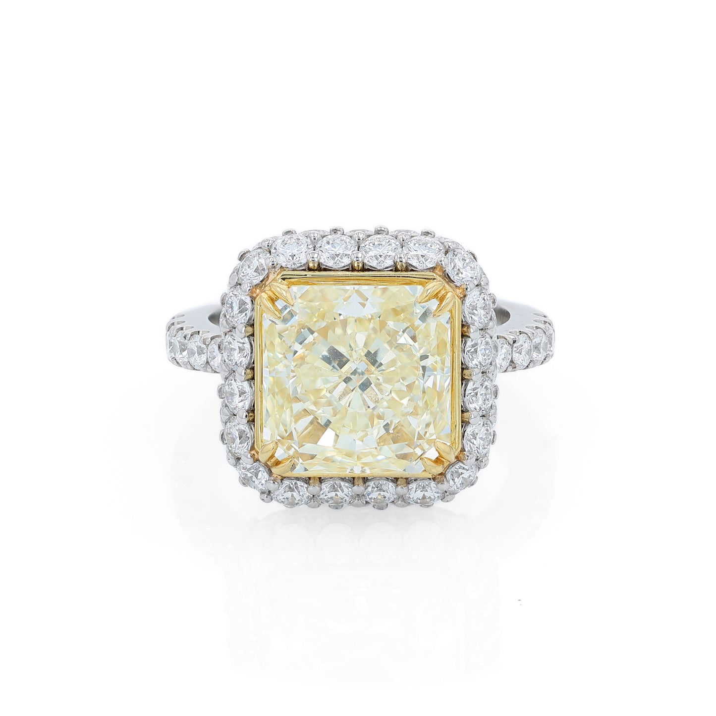 Platinum diamond halo ring with a yellow diamond center on a white background