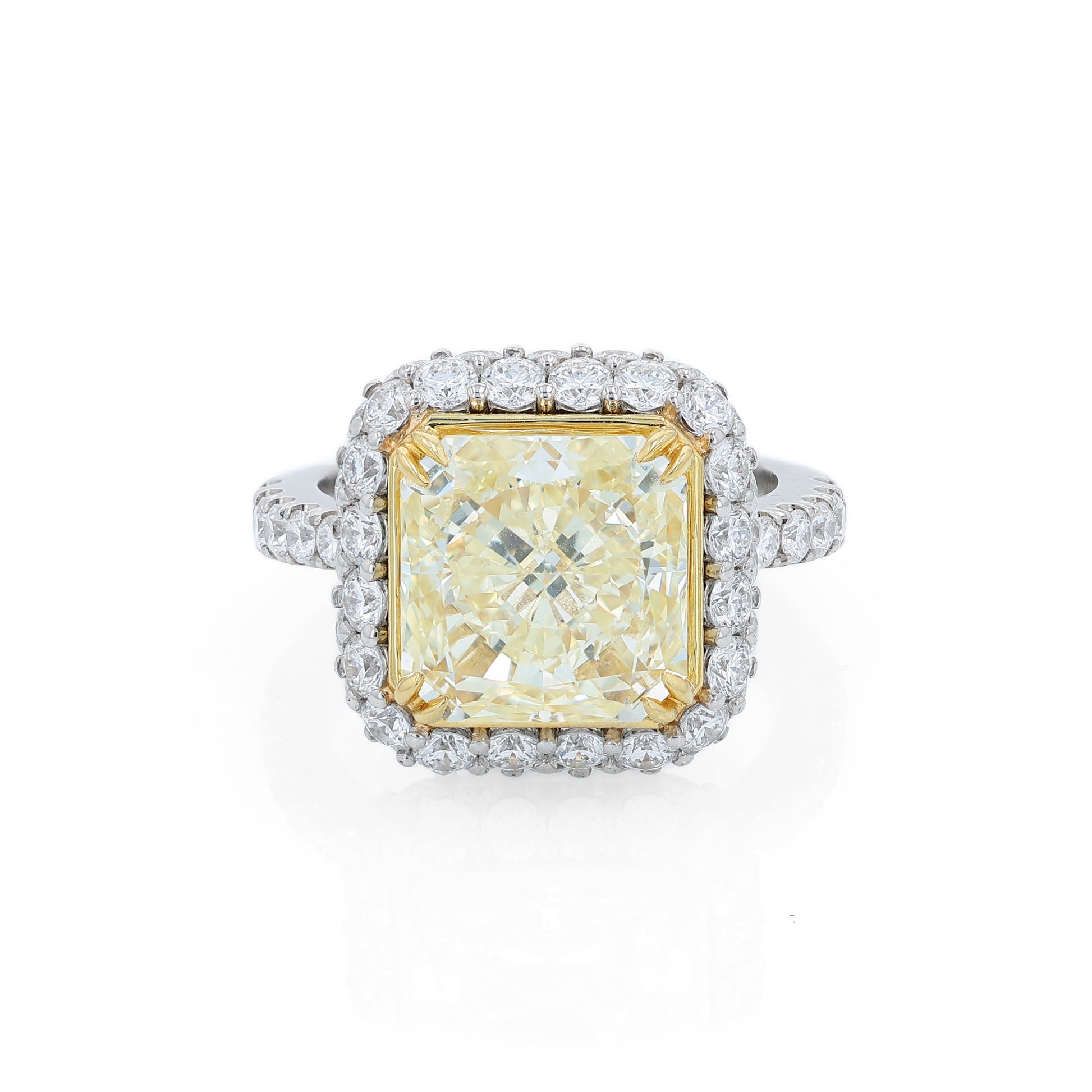 Platinum diamond halo ring with a yellow diamond center on a white background