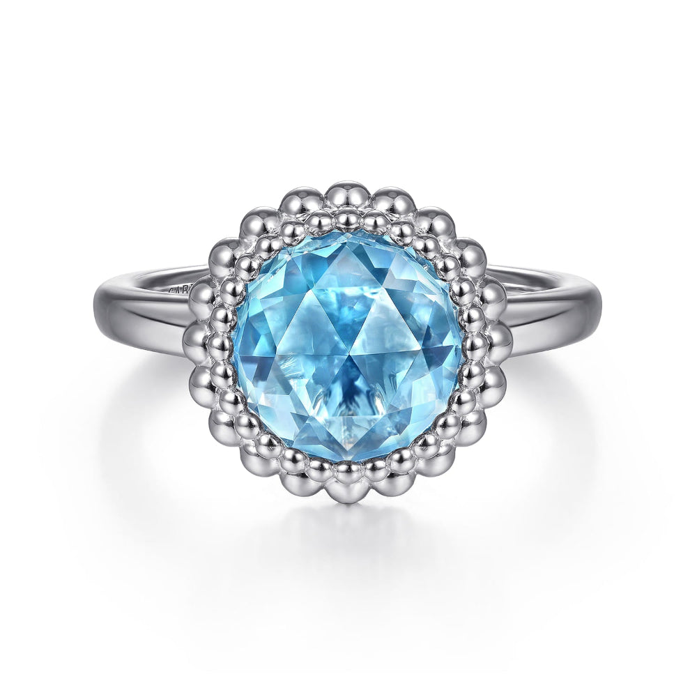 Sterling Silver ring with a  Swiss Blue Topaz and beaded Halo