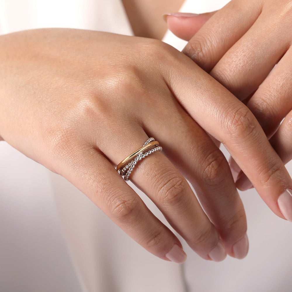Close-up of a hand wearing Silver and gold Criss Cross ring 