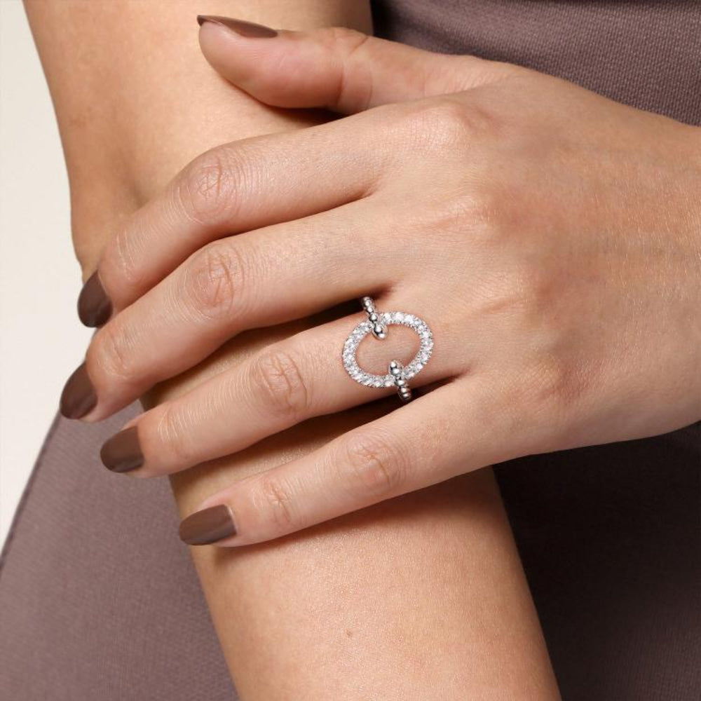 Close-up of a hand wearing silver and white sapphire ring 