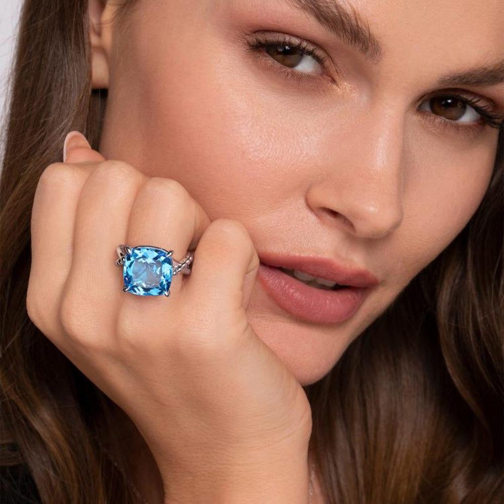 Close-up of a woman wearing a ring with Blue Topaz 