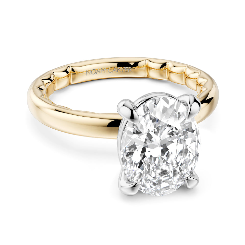 Two-tone gold Noam Carver ring with a large oval diamond on a white background