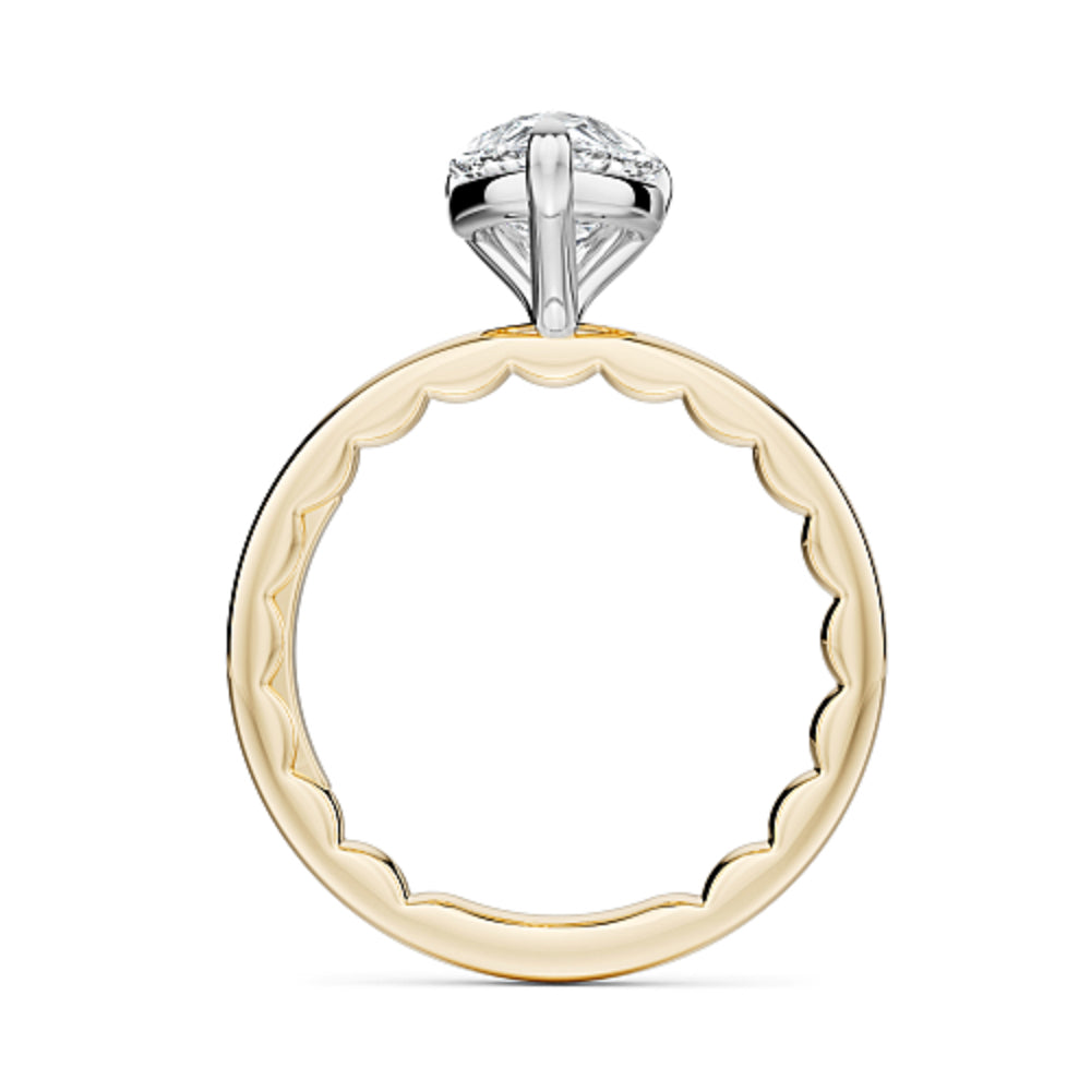 Gold Noam Carver ring with a pear-shaped diamond on a white background