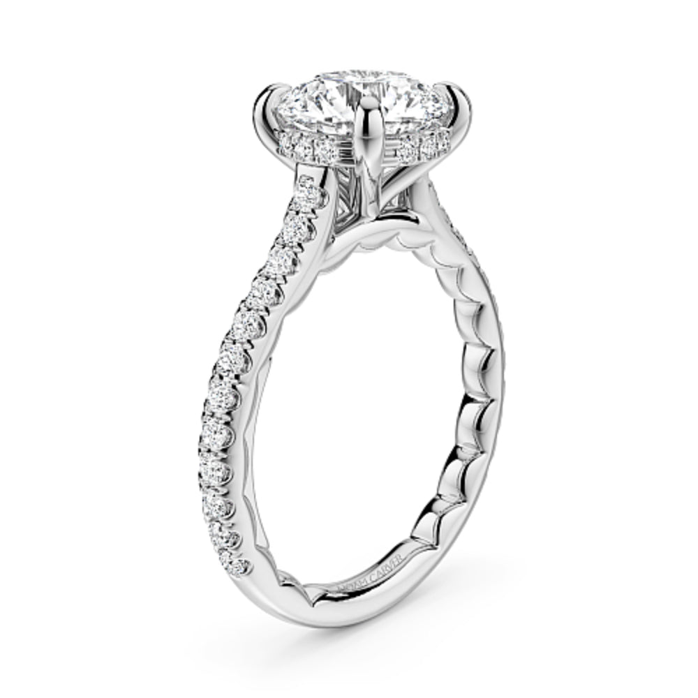 Diamond white gold Noam Carver ring with a round diamond center and diamond sides/hidden halo on a white background