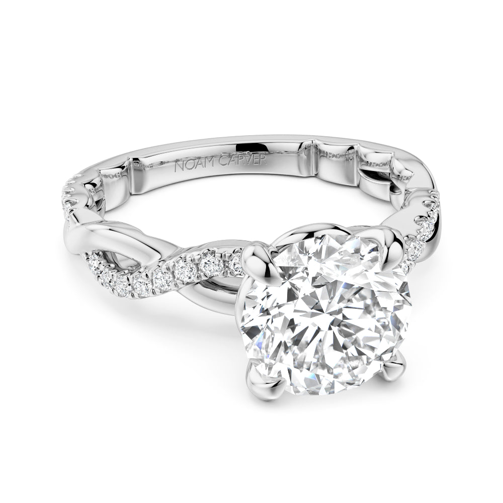 Diamond white gold Noam Carver ring with intricate twist design on a white background