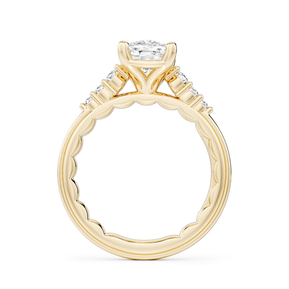 Gold Noam Carver ring with a large elongated cushion diamond and smaller diamonds on the band against a white background