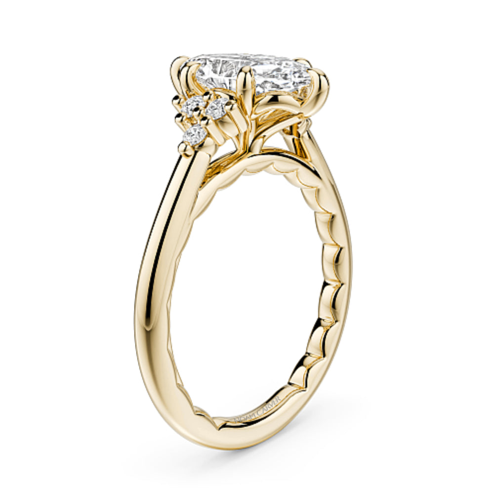 Gold Noam Carver ring with a large marquise diamond and smaller diamonds on a white background