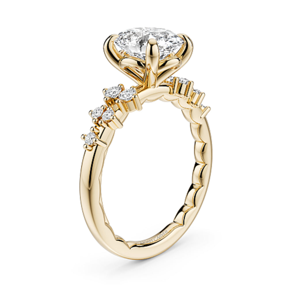 Gold Noam Carver ring with a large oval diamond center and smaller round diamond sides on a white background